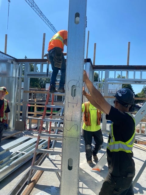 DRYSTAR installer working from a lift on exterior wall framing
