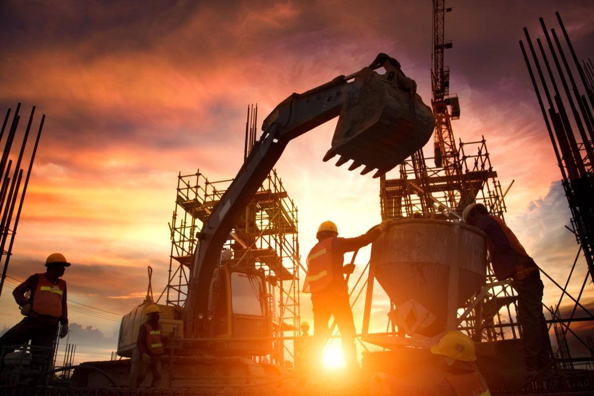 Silhouette of construction workers on site; untracked costs concept