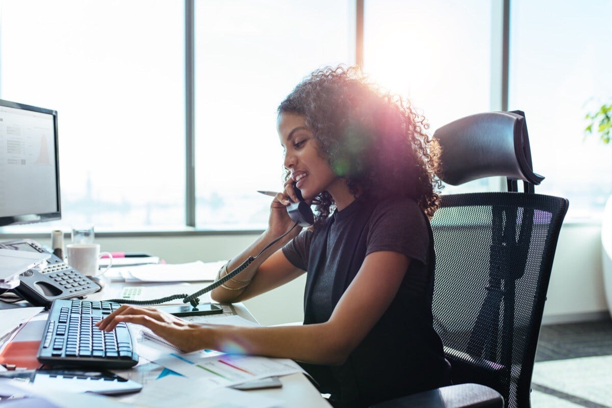 Young woman busy at work in the office; protect your cash flow concept