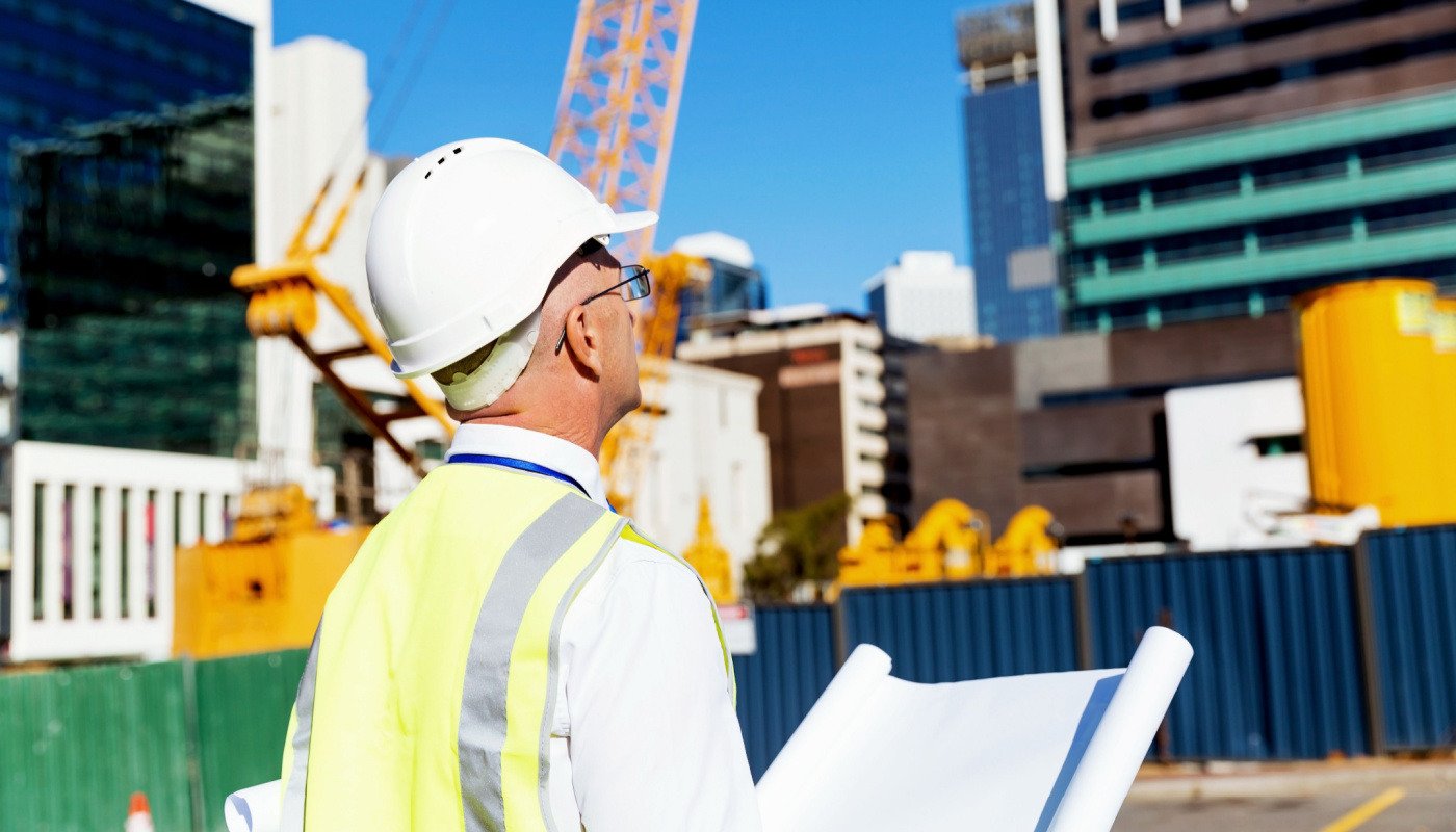 Engineer at construction site; centralized construction project data concept