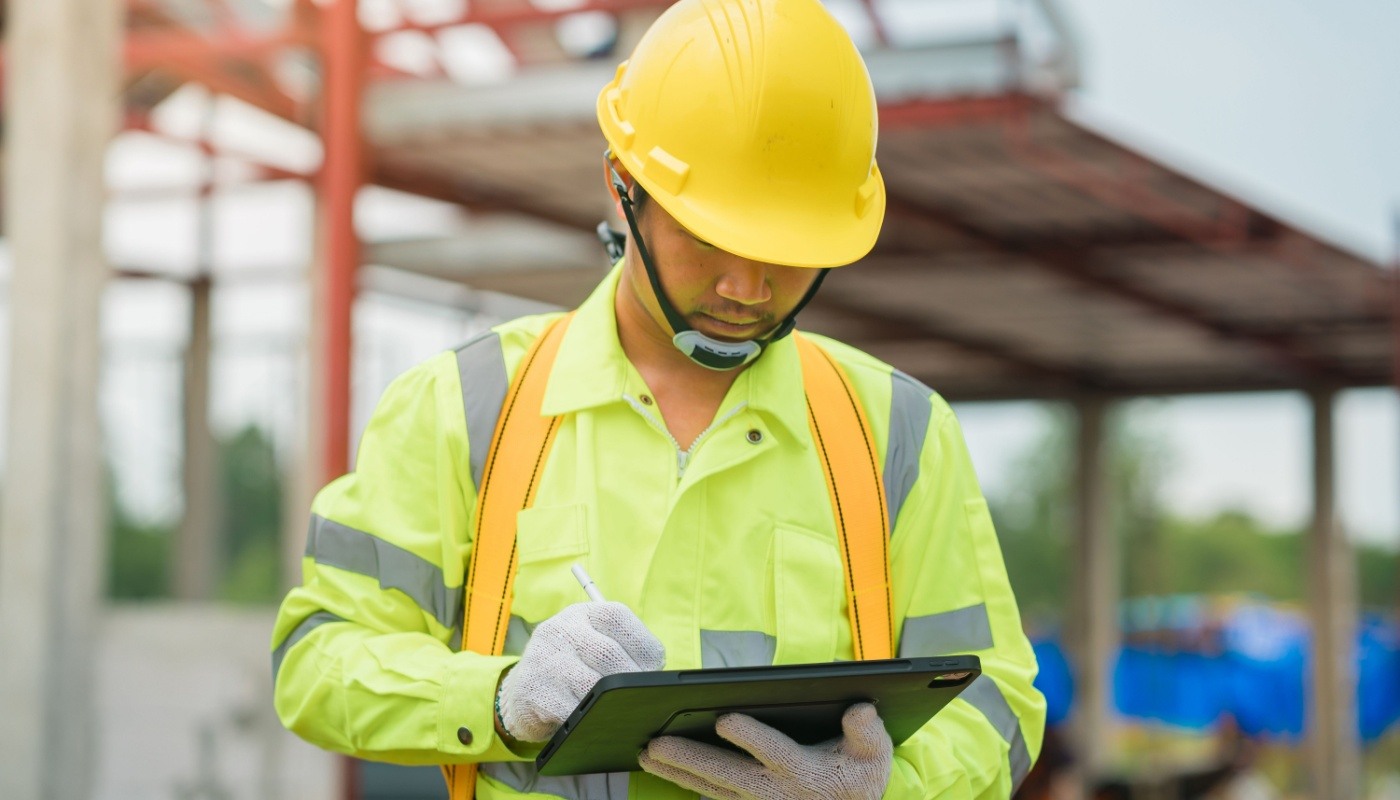 Engineer doing inspection work by checking pattern drawing on ipad; reduce project risks concept