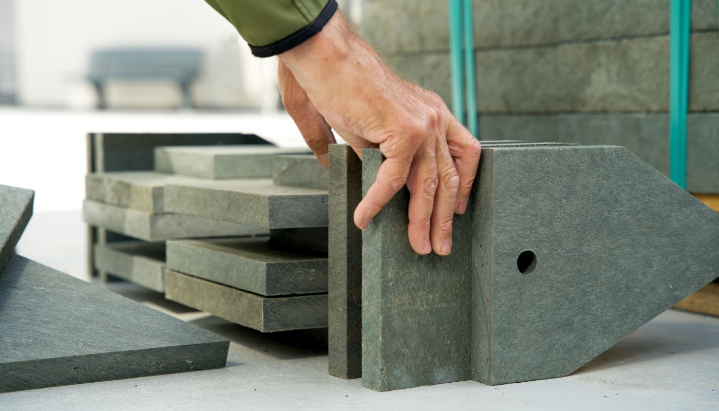 Building material made from recycled plastic waste; environmental benefits concept