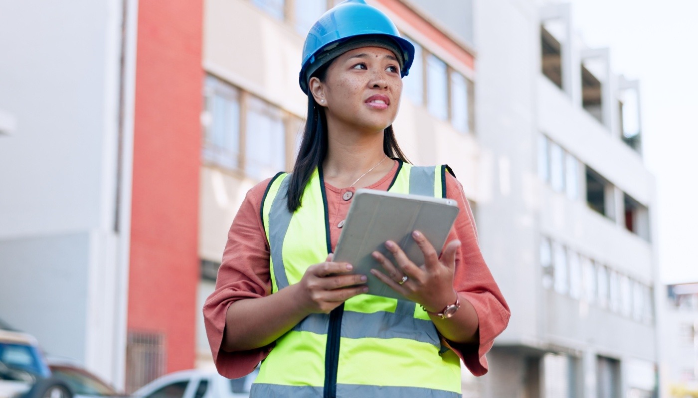 Construction worker with tablet; environmental benefits concept