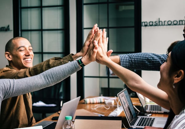 Four Person's High-fiving Each Others