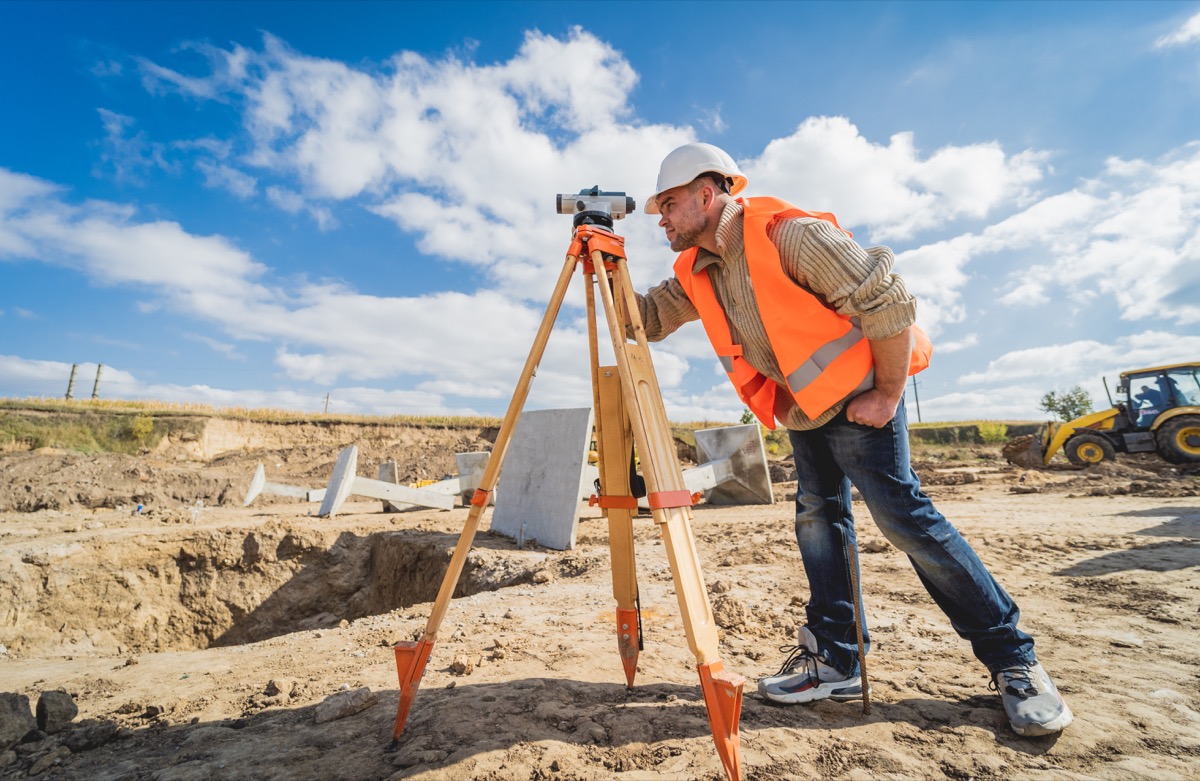 Surveyor at construction site; write better proposals concept