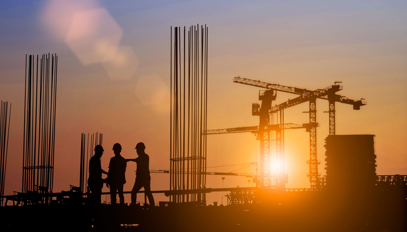 Silhouette of construction team working at a site; construction industry outlook concept