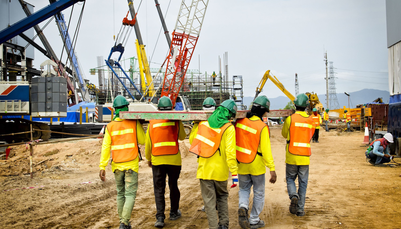 Construction workers carrying heavy object as a team; labor allocation concept