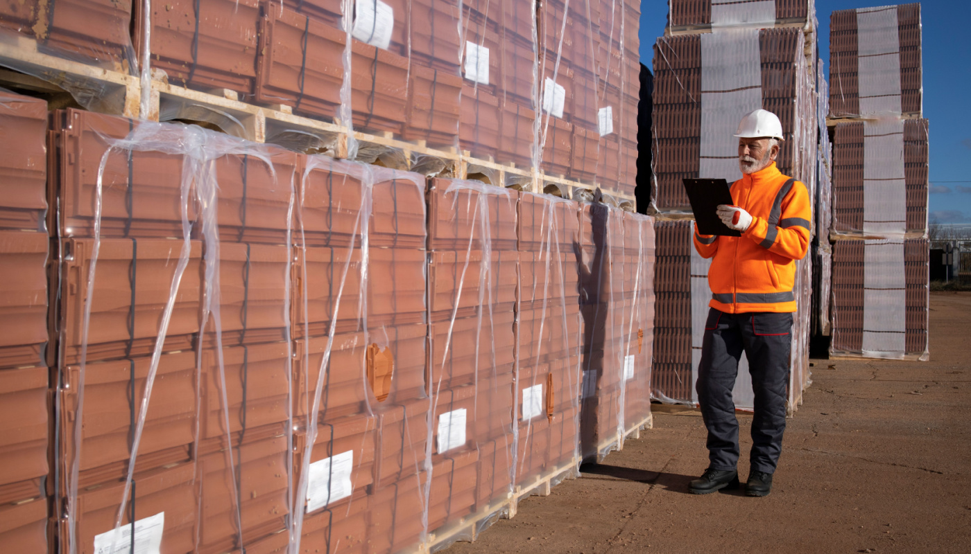 Construction worker supervisor taking inventory of construction materials; reduce material waste concept