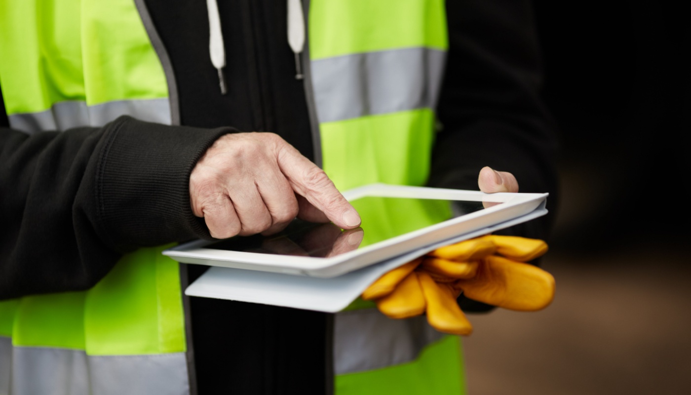 Close-up of construction worker using tablet; construction rework concept