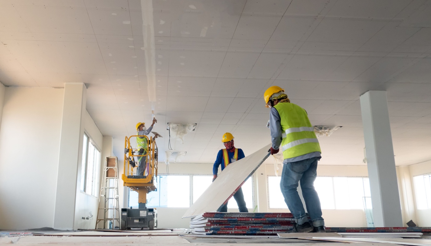 Construction workers installation ceiling work; proactive planning concept